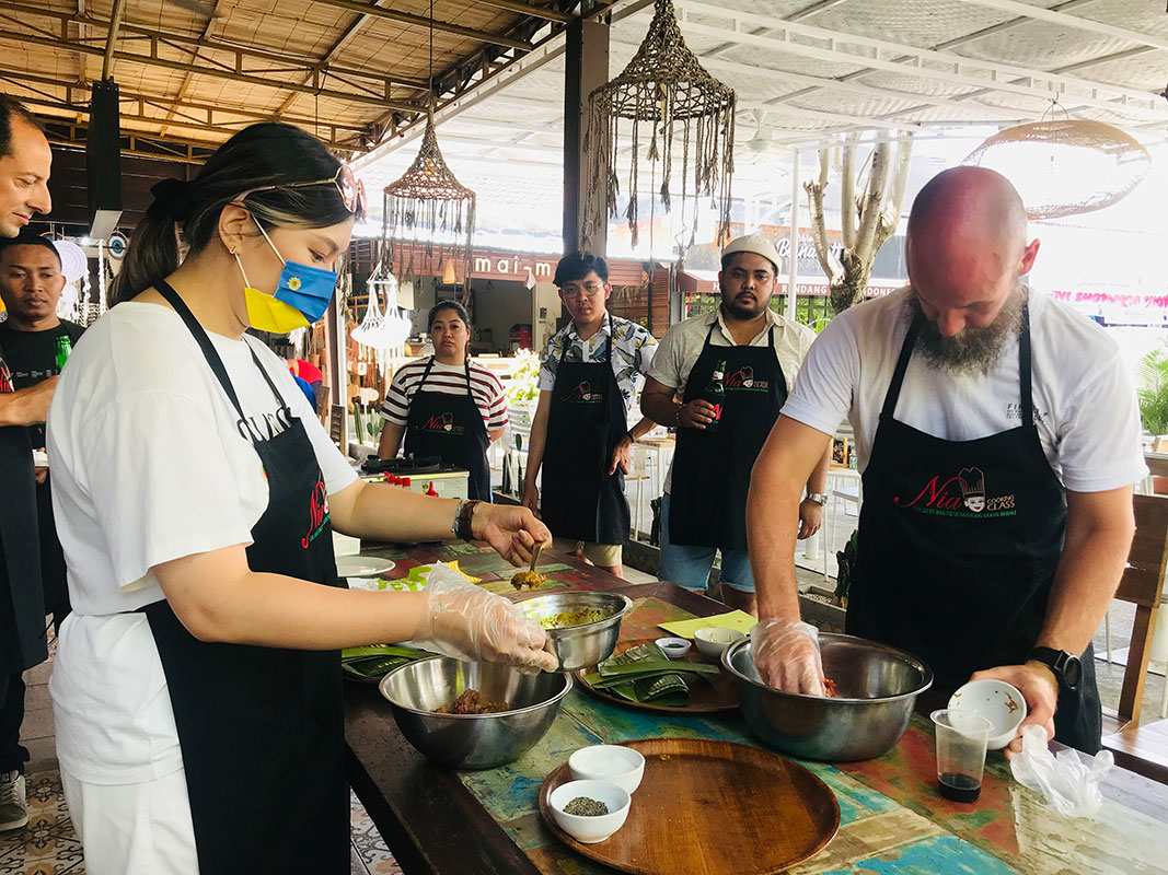 Participants in a Kuta cooking class preparing Balinese food.